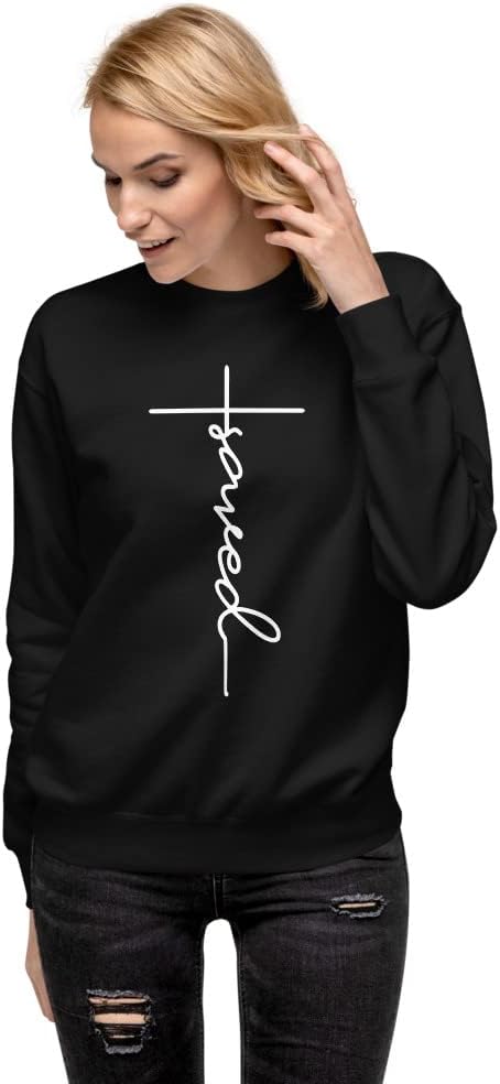 Woman wearing the black Saved cross sweatshirt